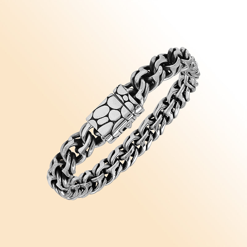 A handcrafted sterling silver rugged woven bracelet featuring a textured push clasp, polished and oxidized detailing, and bold masculine styling perfect for everyday wear.
