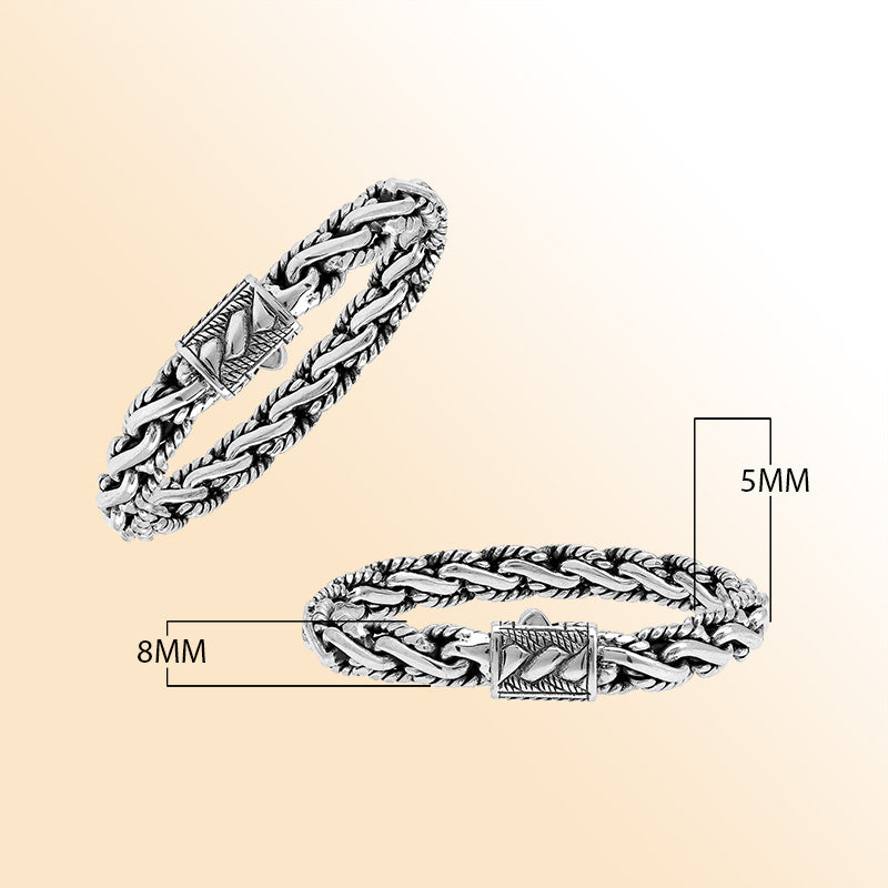 A stunning 925 sterling silver bracelet featuring a braided chain design with a decorative artistic clasp, high-gloss polished finish, and elegant Balinese craftsmanship.