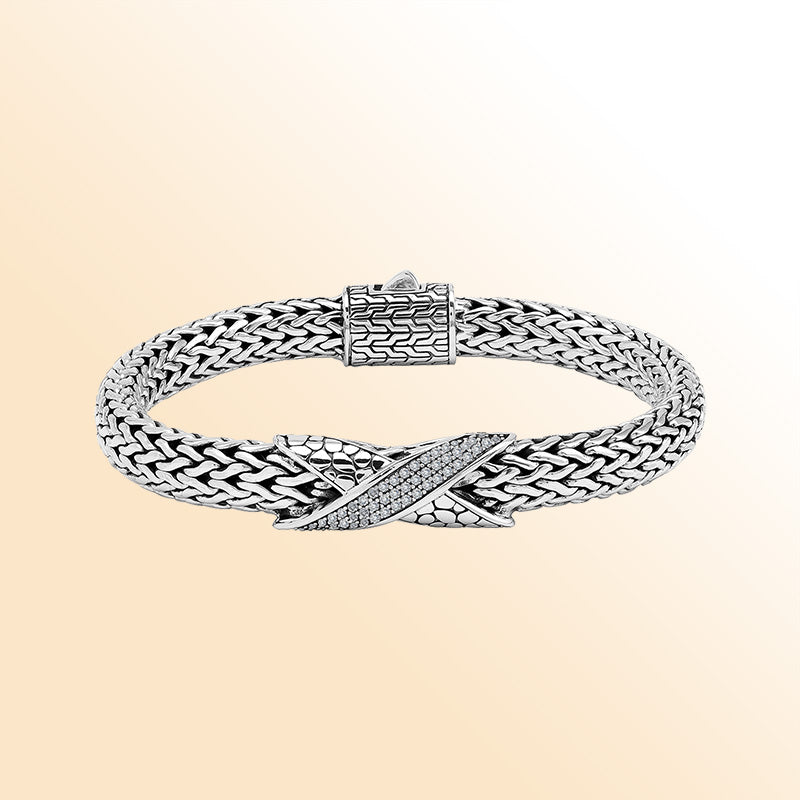 Sterling Silver woven bracelet featuring a sparkling Cubic Zirconia crisscross motif, polished to a bright mirror finish for an expressive accessory with detailed craftsmanship and refined visual appeal.