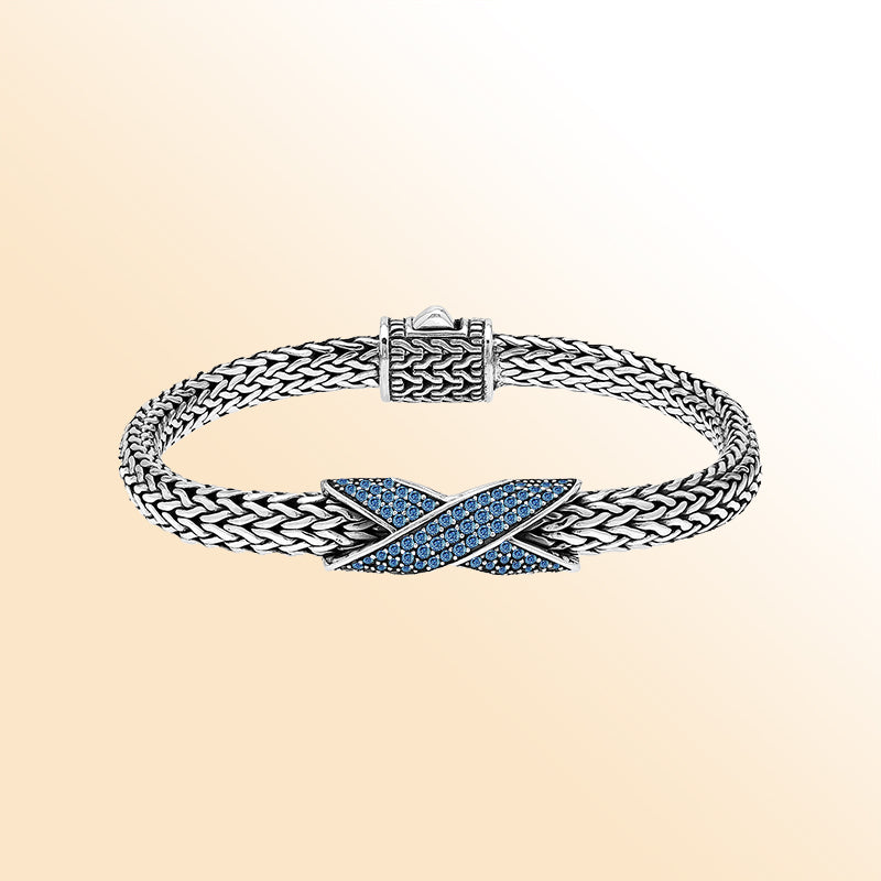 Handcrafted sterling silver woven bracelet featuring a radiant purple Sapphire quartz crossover design from Bali.