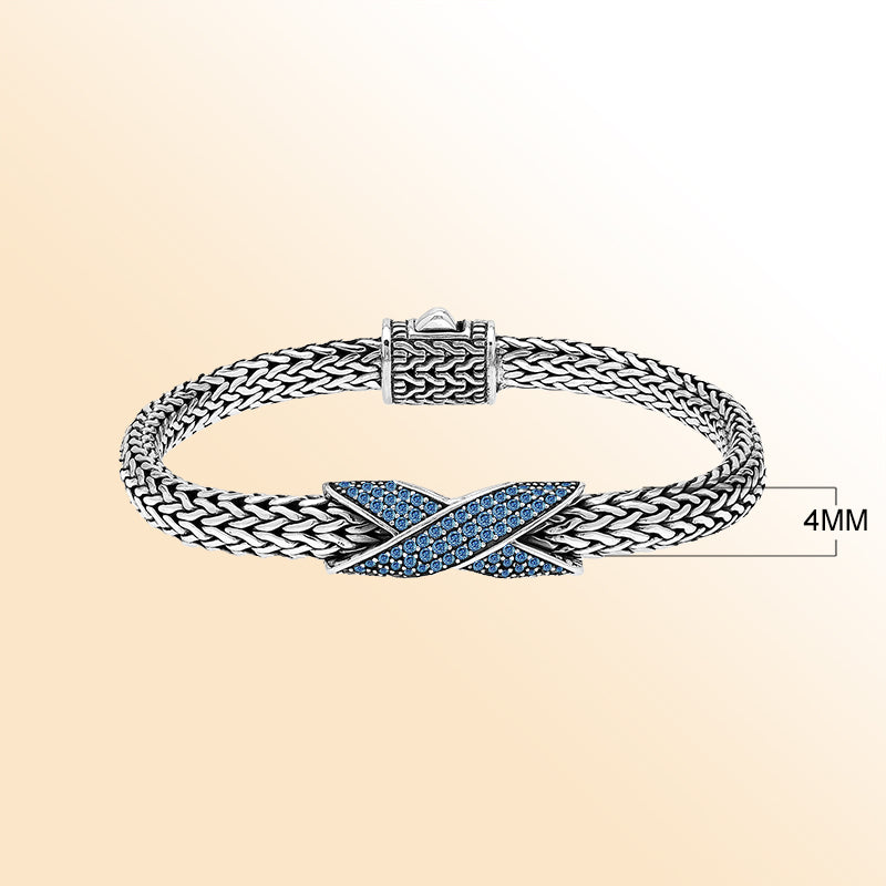 Handcrafted sterling silver woven bracelet featuring a radiant purple Sapphire quartz crossover design from Bali.