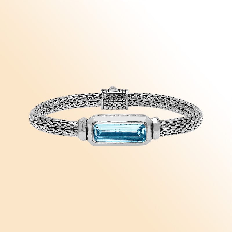 Sterling Silver woven bracelet showcasing a brilliant rectangular Blue Topaz Quartz motif with a polished finish, offering expressive shine, refined craftsmanship, and balanced artistic design.