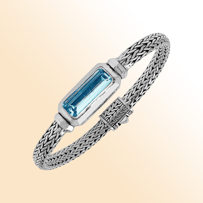 Sterling Silver woven bracelet showcasing a brilliant rectangular Blue Topaz Quartz motif with a polished finish, offering expressive shine, refined craftsmanship, and balanced artistic design.
