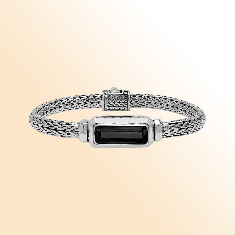 Sterling Silver woven bracelet showcasing a deep Black Onyx rectangular motif, finished with a bright mirror polish to provide expressive contrast and refined handcrafted detail.