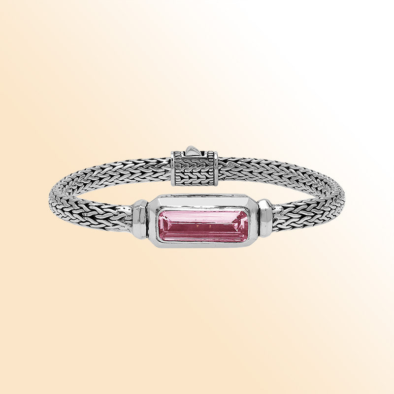 Sterling silver bracelet with handwoven Balinese chain and rectangular pink quartz baguette centerpiece.