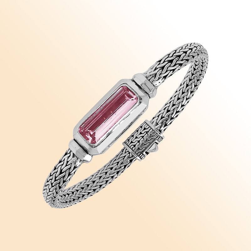 Sterling silver bracelet with handwoven Balinese chain and rectangular pink quartz baguette centerpiece.