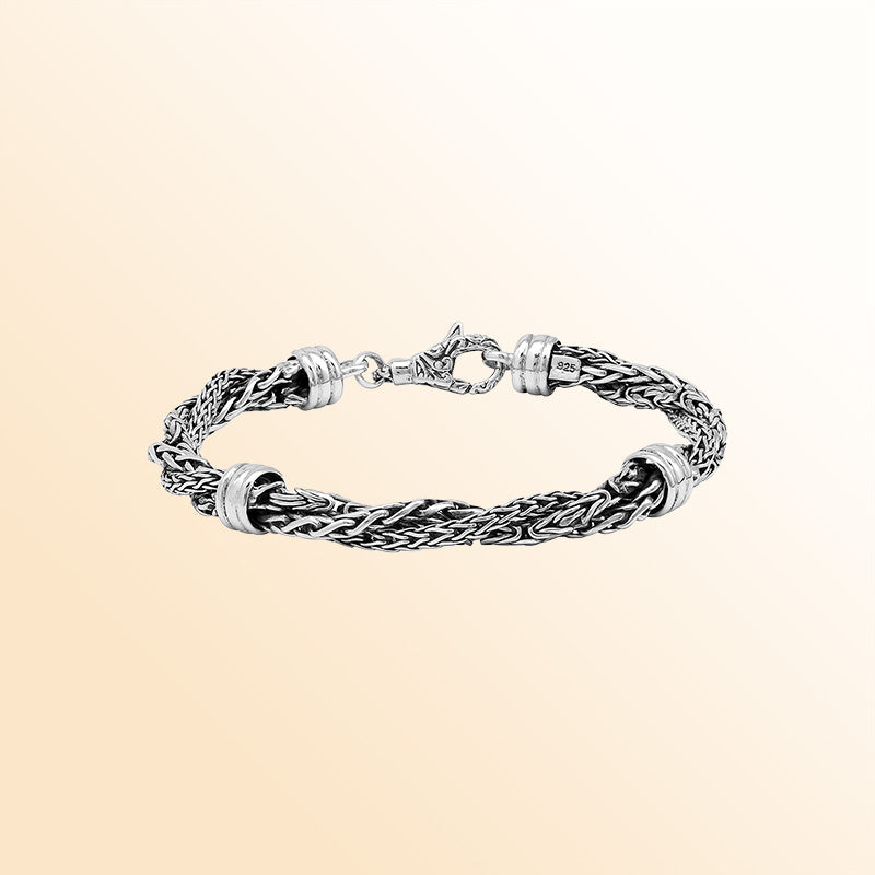 Sterling Silver bracelet with a twisted woven pattern, polished connectors, and an ornate lobster clasp, offering expressive texture, handcrafted detail, and a high-gloss finish.