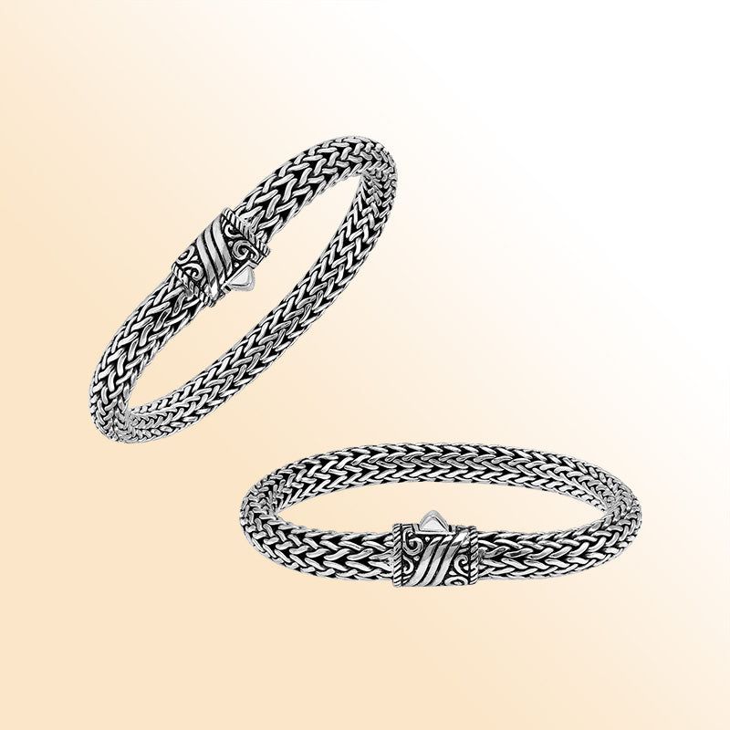 Sterling Silver thick woven bracelet with an artistic push lock, featuring polished detailing and handcrafted texture for an expressive, high-gloss accessory.