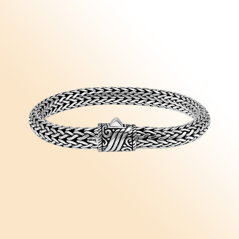 Sterling Silver thick woven bracelet with an artistic push lock, featuring polished detailing and handcrafted texture for an expressive, high-gloss accessory.