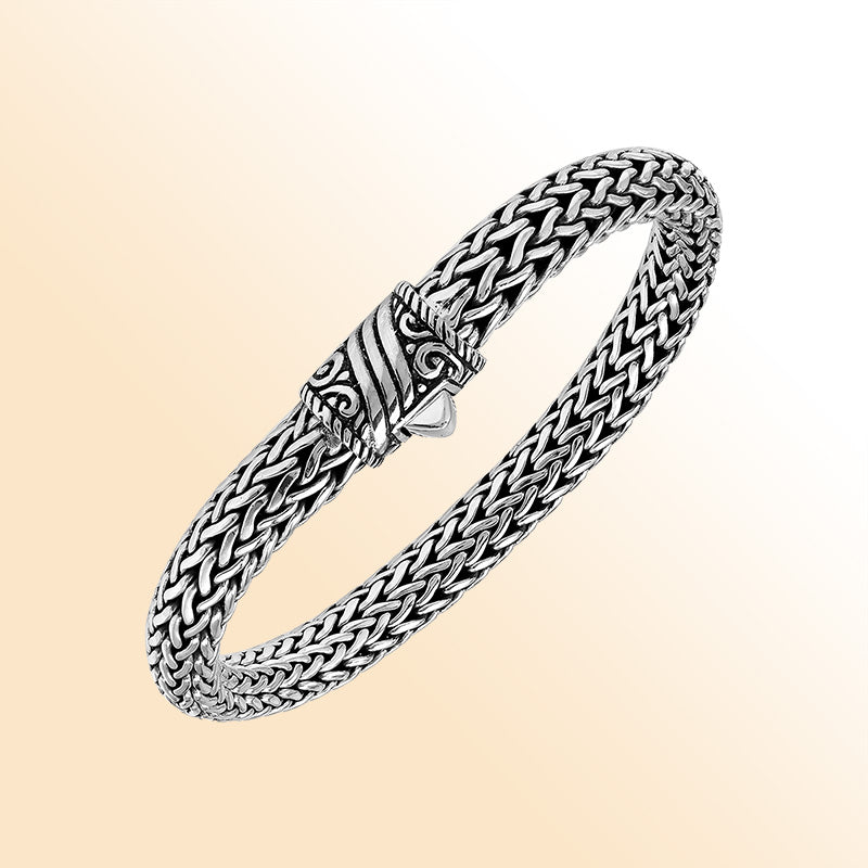 Sterling Silver thick woven bracelet with an artistic push lock, featuring polished detailing and handcrafted texture for an expressive, high-gloss accessory.