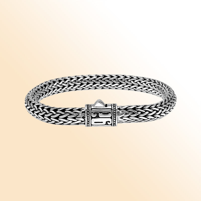 Sterling Silver thick woven bracelet with a sculpted push lock and a mirror-polished finish, offering expressive handcrafted character and refined detailing.