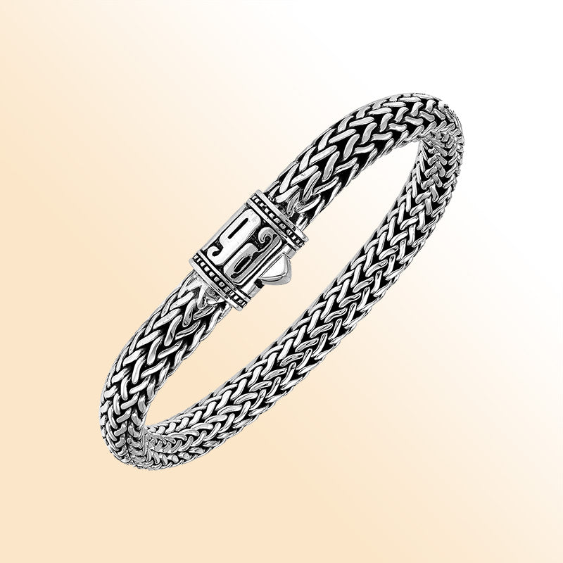 Sterling Silver thick woven bracelet with a sculpted push lock and a mirror-polished finish, offering expressive handcrafted character and refined detailing.