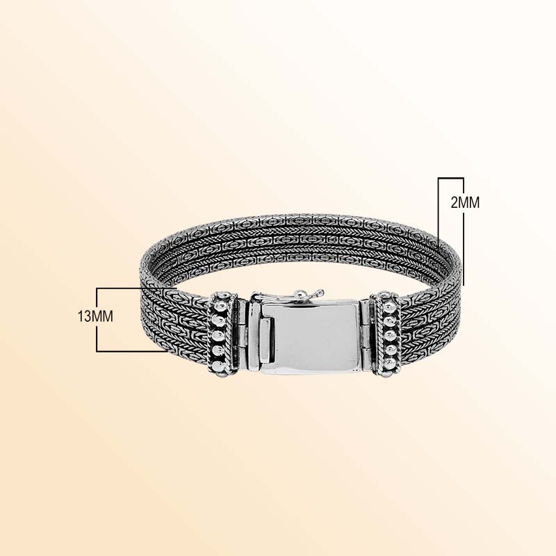 Sterling silver chain panel bracelet with layered handcrafted design and rich polished silver texture.