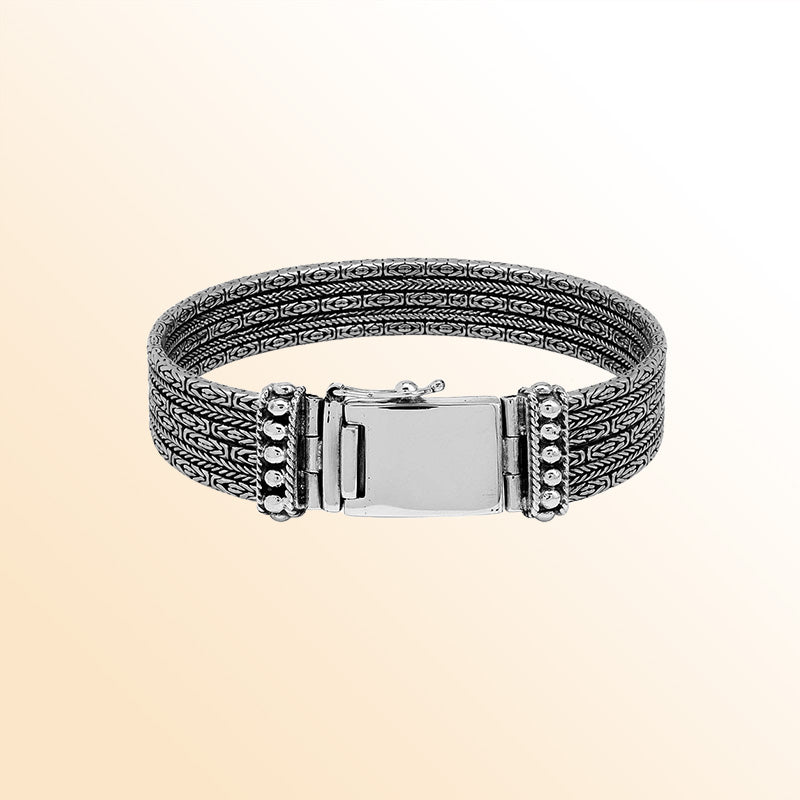 Sterling silver chain panel bracelet with layered handcrafted design and rich polished silver texture.