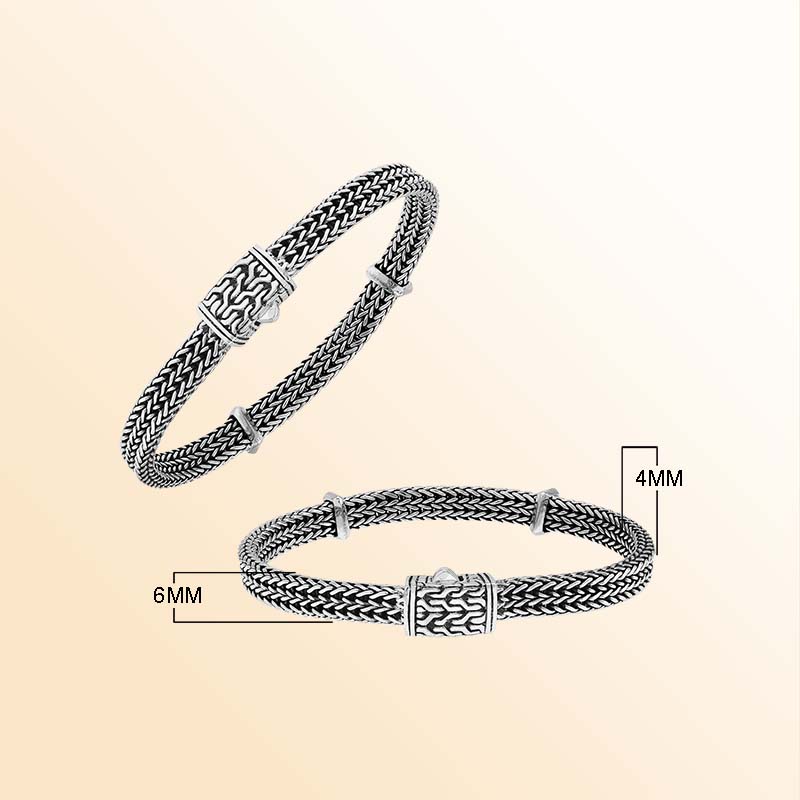 Sterling silver Heritage Weave artisan bracelet with layered braided strands, sculpted spacers, patterned push clasp, and oxidized texture
