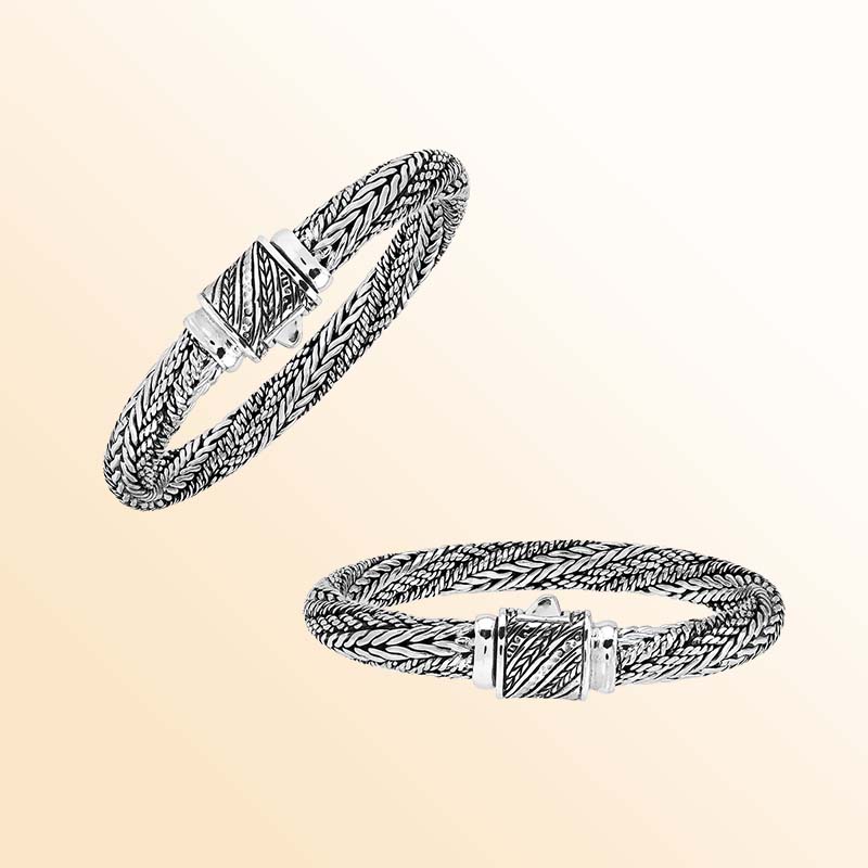 Artisan sterling silver bracelet with richly layered braided strands, detailed woven textures, contrasting oxidized accents, and an engraved decorative push clasp.