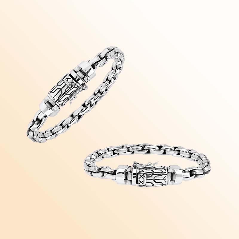 Artisan sterling silver bracelet showcasing bold braided round links, luminous polished surfaces, subtle oxidized depth, and a distinctive engraved box clasp.