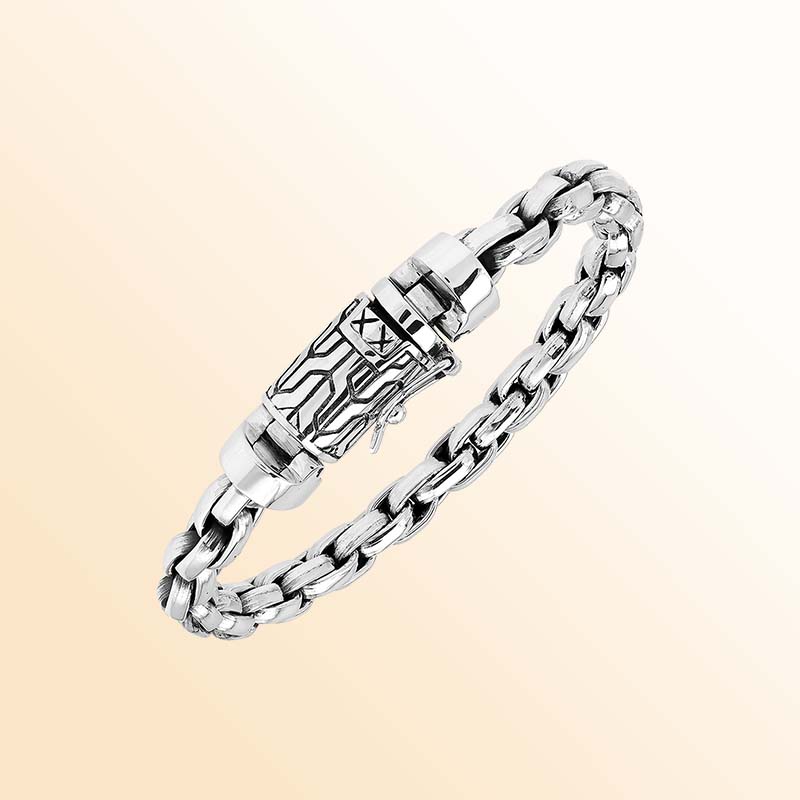 Artisan sterling silver bracelet showcasing bold braided round links, luminous polished surfaces, subtle oxidized depth, and a distinctive engraved box clasp.