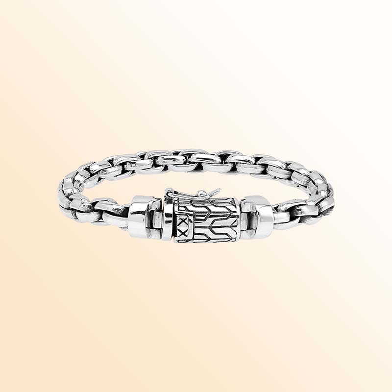 Artisan sterling silver bracelet showcasing bold braided round links, luminous polished surfaces, subtle oxidized depth, and a distinctive engraved box clasp.