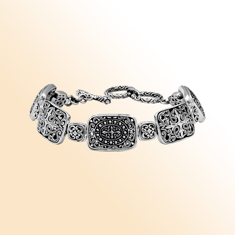 Sterling Silver bracelet featuring artistic rectangular scroll panels, sculpted detailing, decorative connectors, and a polished toggle lock inspired by Balinese craftsmanship.