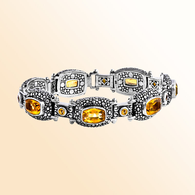 An artisan sterling silver bracelet featuring a mix of Citrine Quartz and Smokey Quartz, enhanced with granulated textures, oxidized details, and a smooth push clasp for stylish everyday wear.