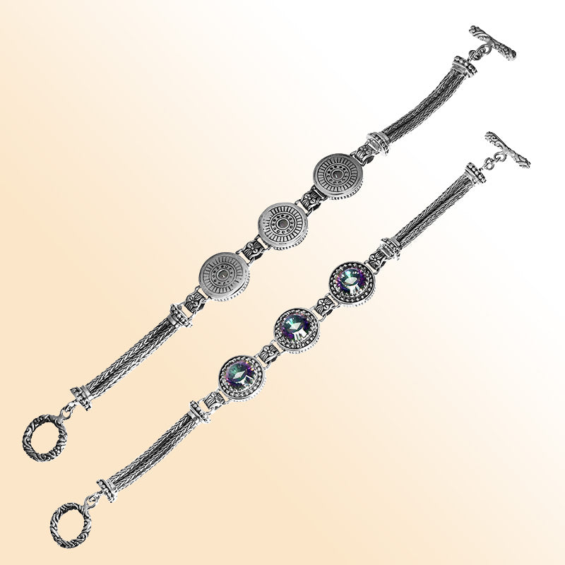 Elegant sterling silver bracelet with Mystic Quartz stones, detailed Balinese motifs, multi-strand chain work, and a decorative toggle clasp.