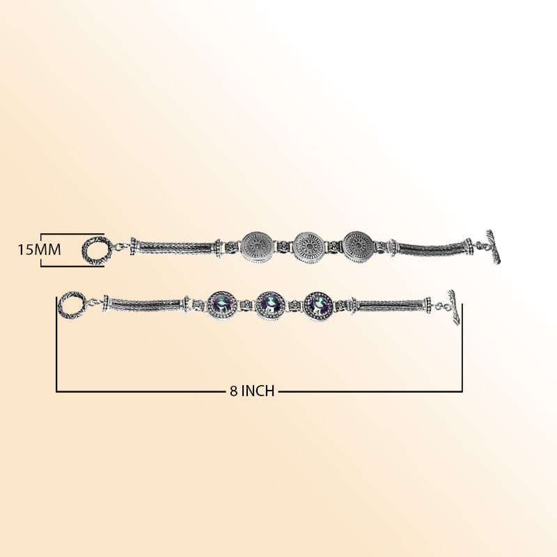 Elegant sterling silver bracelet with Mystic Quartz stones, detailed Balinese motifs, multi-strand chain work, and a decorative toggle clasp.