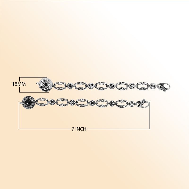 Retail sterling silver bracelet featuring polished Black Onyx set in ornate Balinese-style carvings with detailed patterned links and a lobster lock for elegant daily wear.