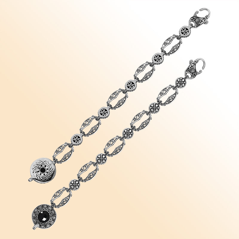 Retail sterling silver bracelet featuring polished Black Onyx set in ornate Balinese-style carvings with detailed patterned links and a lobster lock for elegant daily wear.