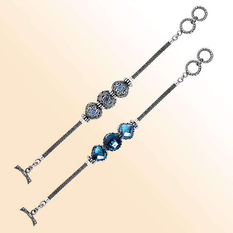 Retail sterling silver bracelet highlighting radiant Blue Topaz Quartz stones set in ornate Balinese frames with woven chain details and a toggle lock for elegant everyday wear.