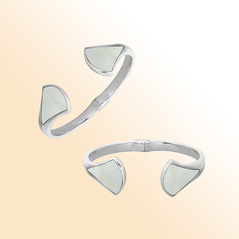 Retail sterling silver cuff with luminous Mother Of Pearl inlays set on sculpted open ends, featuring a polished finish and hinge lock for elegant daily wear.