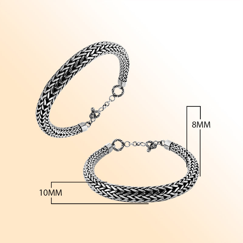 Retail sterling silver bracelet featuring a bold woven Balinese chain pattern with oxidized accents, polished ends, and a toggle lock for elegant daily styling.