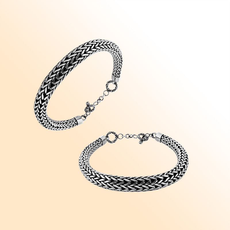 Retail sterling silver bracelet featuring a bold woven Balinese chain pattern with oxidized accents, polished ends, and a toggle lock for elegant daily styling.