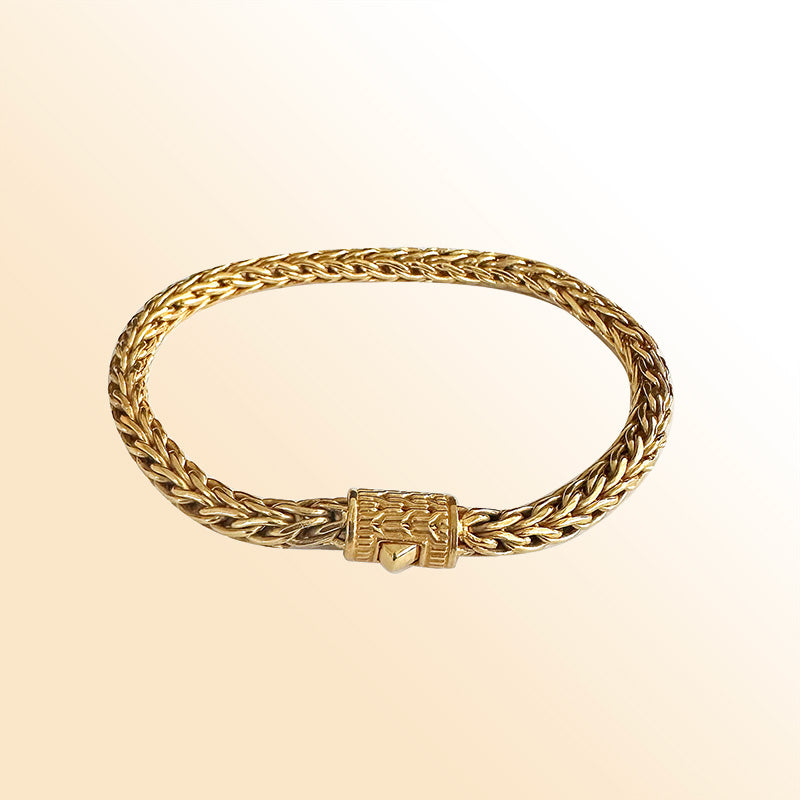 Retail 18K gold bracelet featuring a polished 5MM woven Balinese chain with elegant braided detailing and a secure push clasp for luxurious everyday wear.