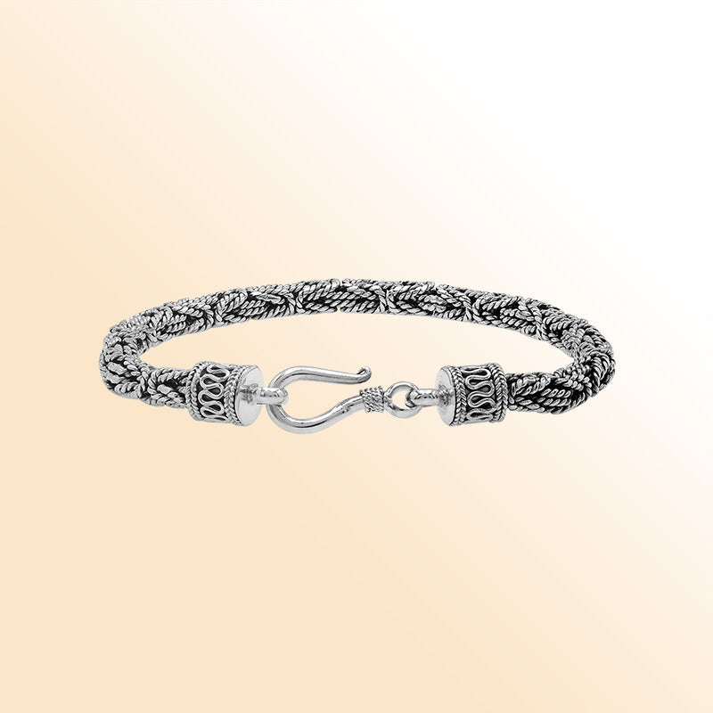 Retail sterling silver bracelet featuring a polished and oxidized 4MM woven Balinese chain with a secure lobster lock for refined daily wear.