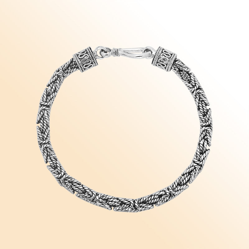 Retail sterling silver bracelet featuring a polished and oxidized 4MM woven Balinese chain with a secure lobster lock for refined daily wear.