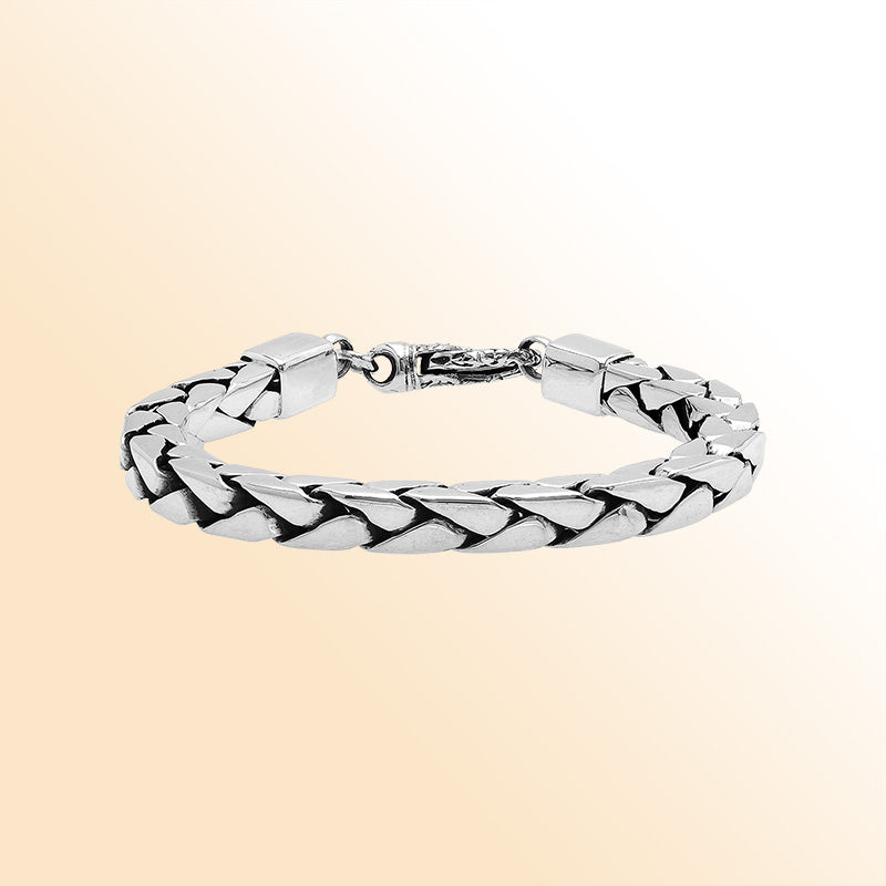 Retail sterling silver bracelet showcasing a polished 4MM flat-weave chain with oxidized details and a durable, secure lobster lock.