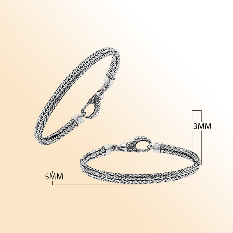 An elegant sterling silver braided chain bracelet with an artistic lobster clasp, featuring smooth texture, high-gloss polish, and intricate craftsmanship ideal for timeless modern style.
