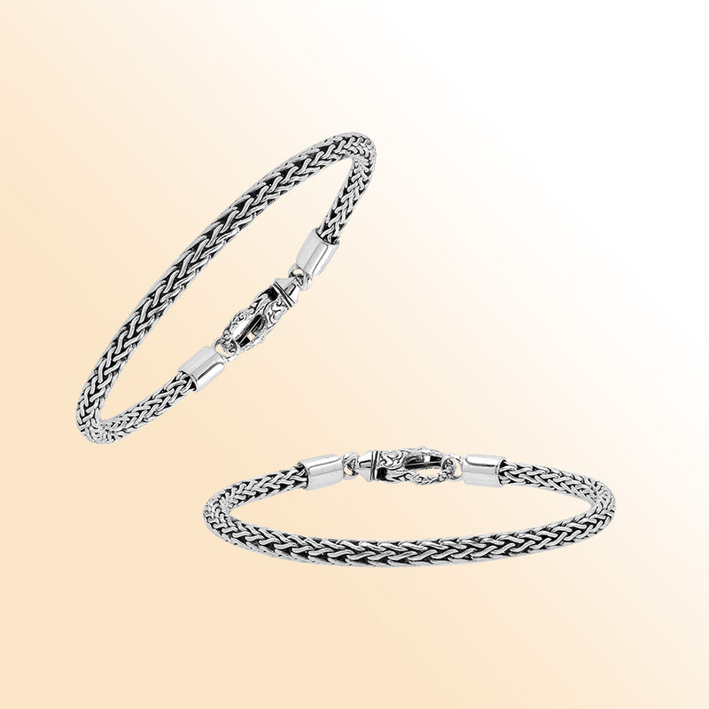 Retail sterling silver bracelet with a 4MM woven chain featuring polished and oxidized detailing and a decorative lobster lock designed for secure everyday wear.
