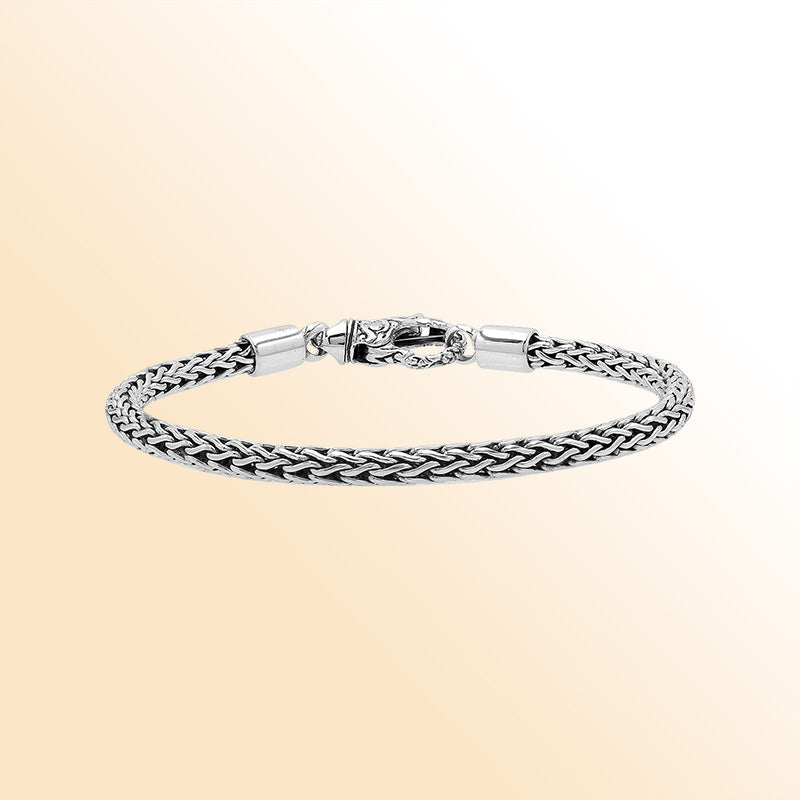 Retail sterling silver bracelet with a 4MM woven chain featuring polished and oxidized detailing and a decorative lobster lock designed for secure everyday wear.