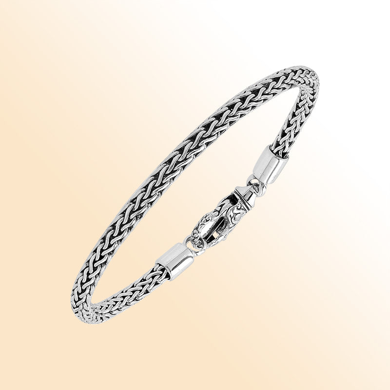 Retail sterling silver bracelet with a 4MM woven chain featuring polished and oxidized detailing and a decorative lobster lock designed for secure everyday wear.