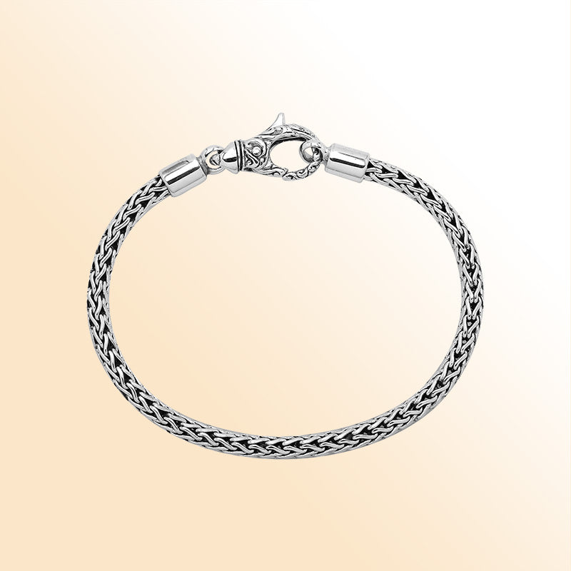 Retail sterling silver bracelet with a 4MM woven chain featuring polished and oxidized detailing and a decorative lobster lock designed for secure everyday wear.
