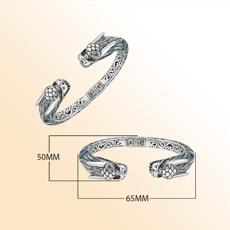 Handcrafted sterling silver phoenix bangle with Abalone Shell, featuring ornate Balinese engraving and a secure hinge lock for beauty, comfort, and everyday meaningful style.