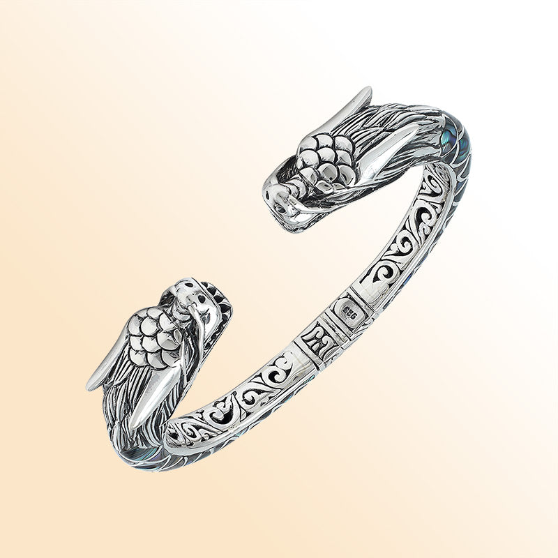 Handcrafted sterling silver phoenix bangle with Abalone Shell, featuring ornate Balinese engraving and a secure hinge lock for beauty, comfort, and everyday meaningful style.