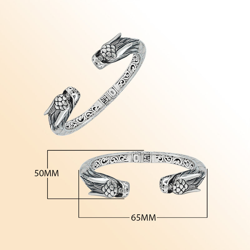 Handcrafted sterling silver phoenix guardian bangle featuring Mother of Pearl accents, ornate Balinese scroll engravings, and a secure hinge lock for a beautifully detailed, meaningful accessory.