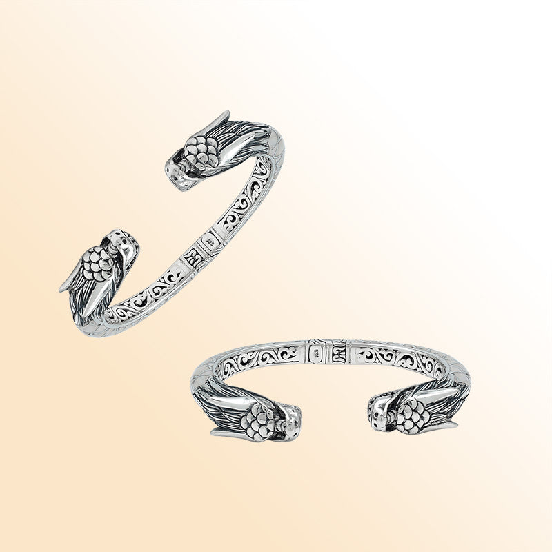 Handcrafted sterling silver phoenix guardian bangle featuring Mother of Pearl accents, ornate Balinese scroll engravings, and a secure hinge lock for a beautifully detailed, meaningful accessory.