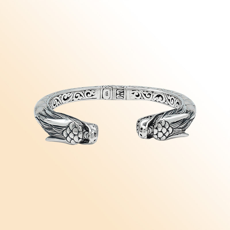 Handcrafted sterling silver phoenix guardian bangle featuring Mother of Pearl accents, ornate Balinese scroll engravings, and a secure hinge lock for a beautifully detailed, meaningful accessory.