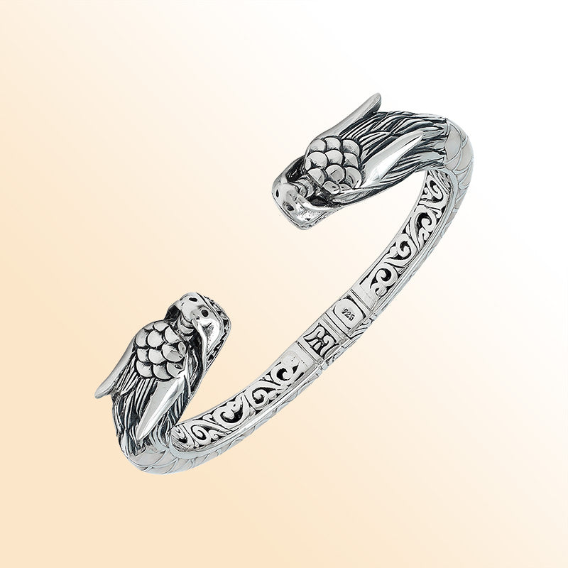 Handcrafted sterling silver phoenix guardian bangle featuring Mother of Pearl accents, ornate Balinese scroll engravings, and a secure hinge lock for a beautifully detailed, meaningful accessory.
