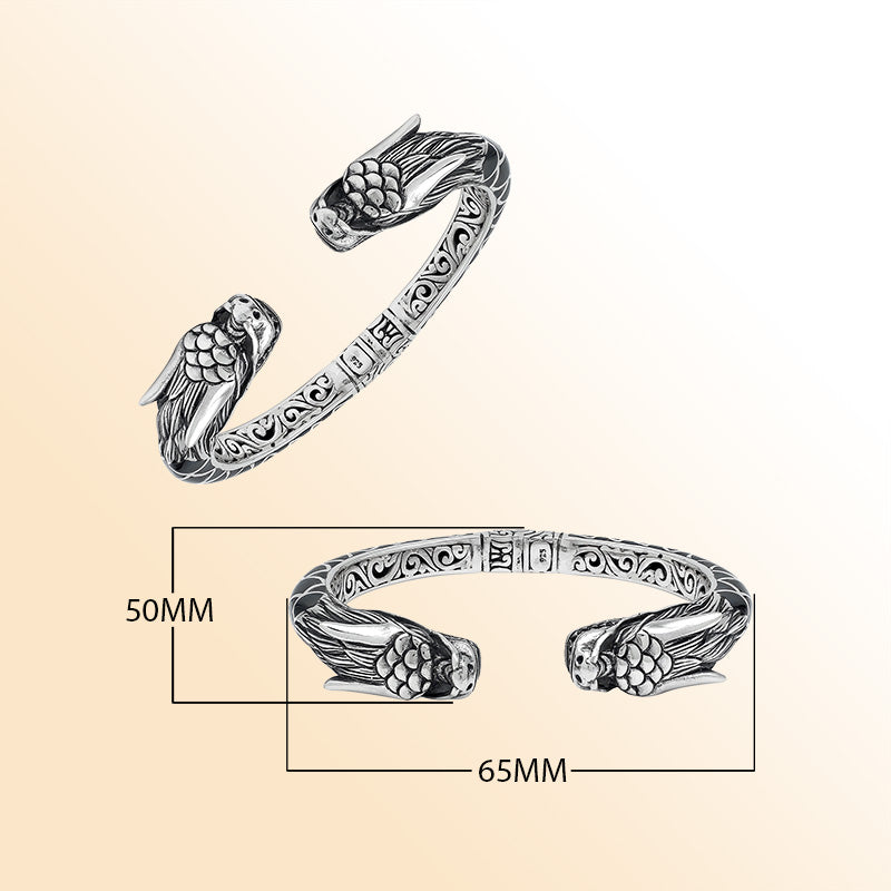 Handcrafted sterling silver phoenix guardian bangle featuring Black Shell accents, detailed Balinese scroll engravings, and a secure hinge lock for a meaningful and expressive artisan accessory.