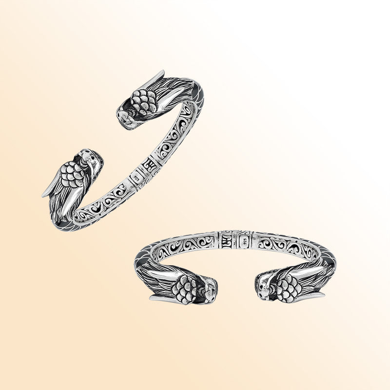Handcrafted sterling silver phoenix guardian bangle featuring Black Shell accents, detailed Balinese scroll engravings, and a secure hinge lock for a meaningful and expressive artisan accessory.